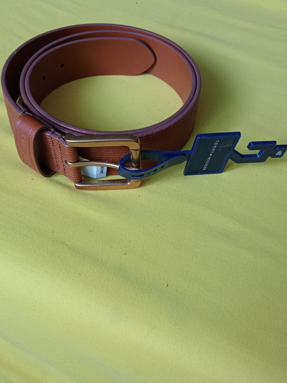 Tommy Hilfiger textured leather belt in a brown color with a brushed gold-tone b